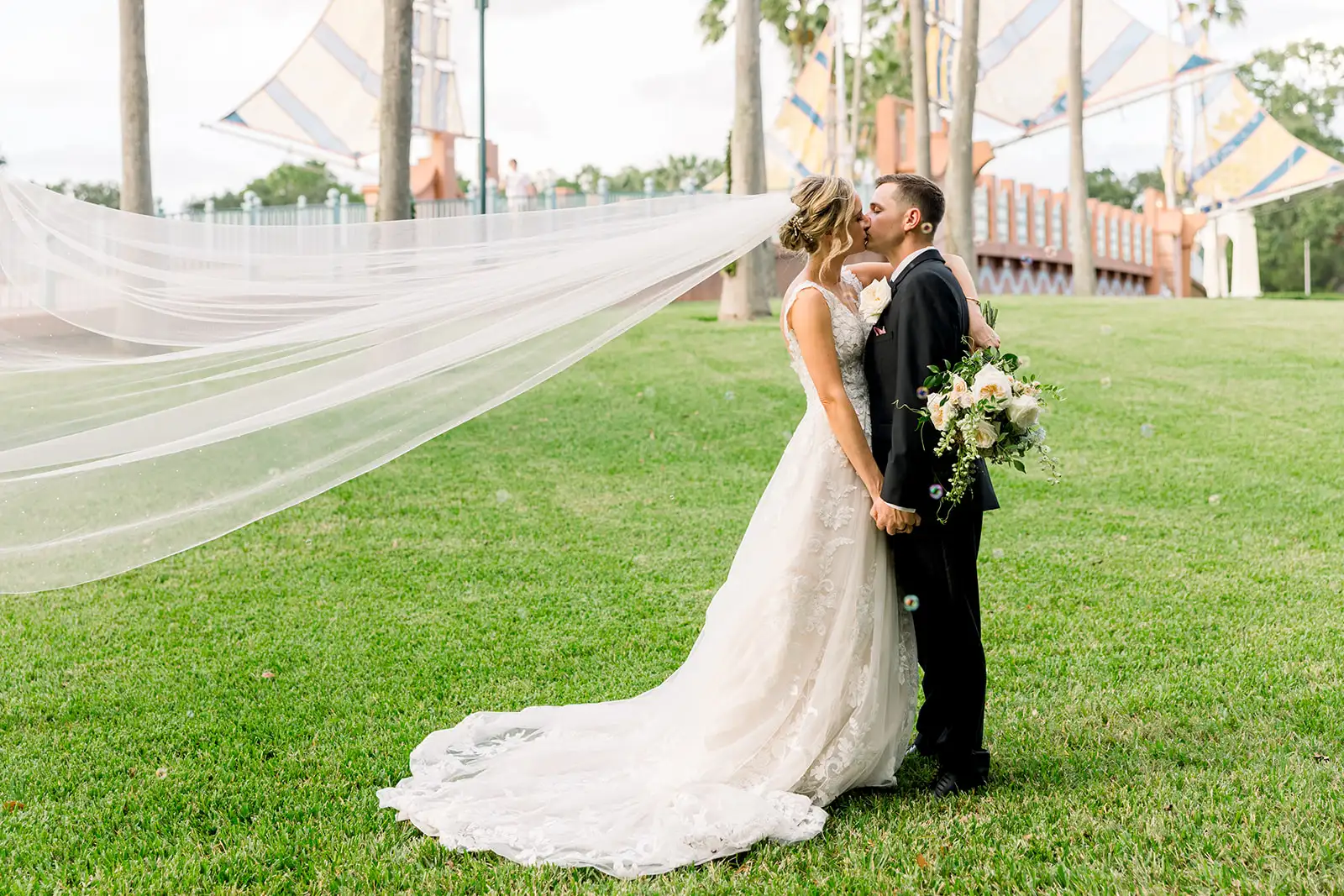 Bride and groom kissing on the lawn at The Swan Resort Walt Disney World