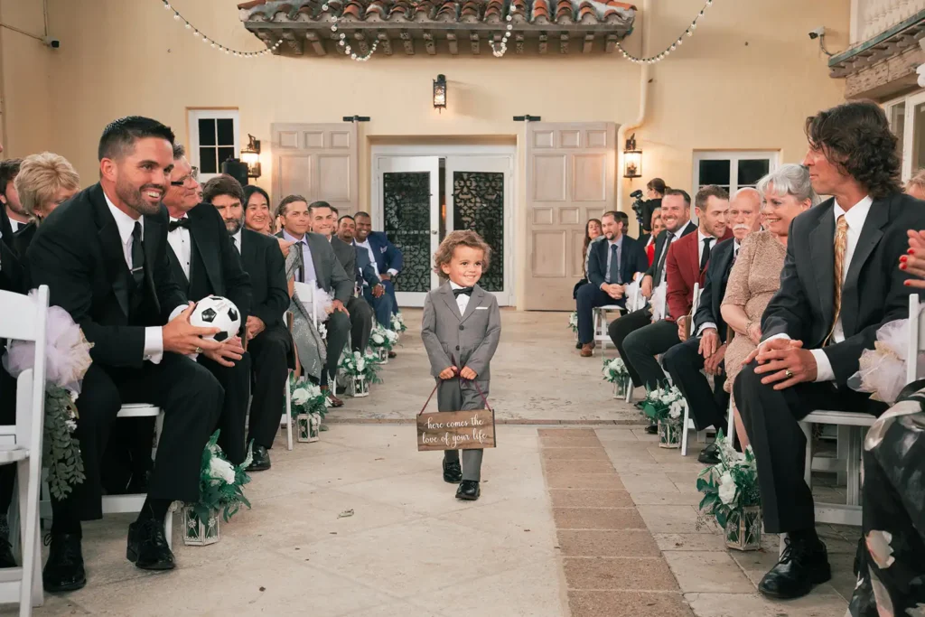 adorable ring bearer walks down aisle at wedding