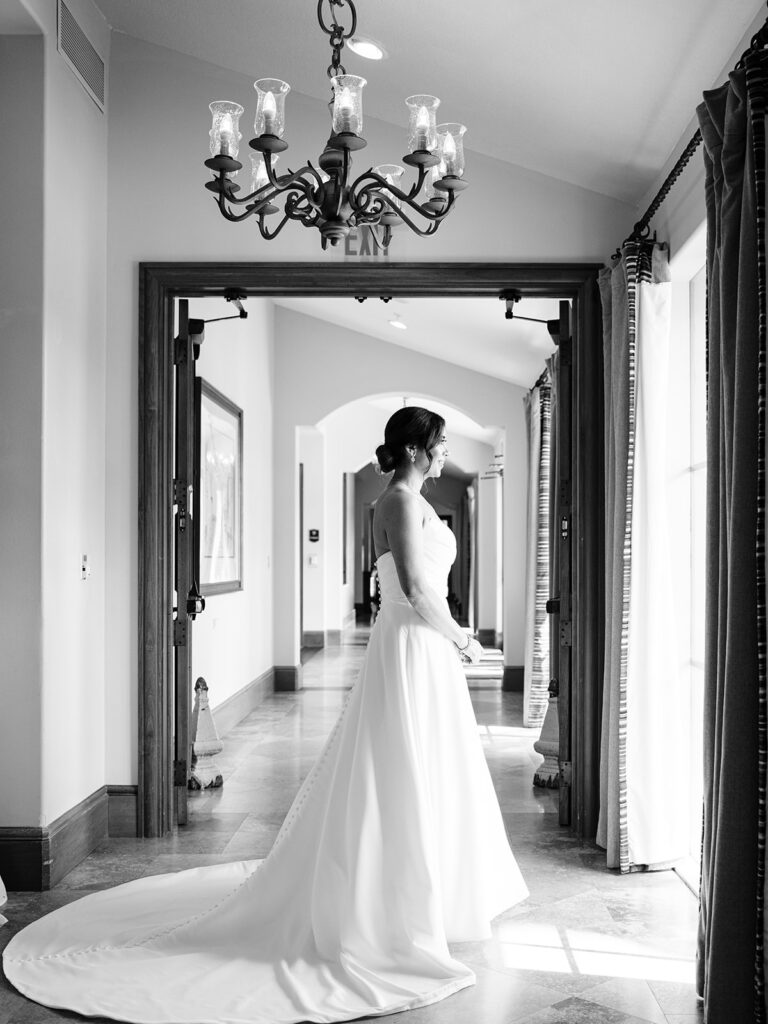black and white photo fo bride staring out window