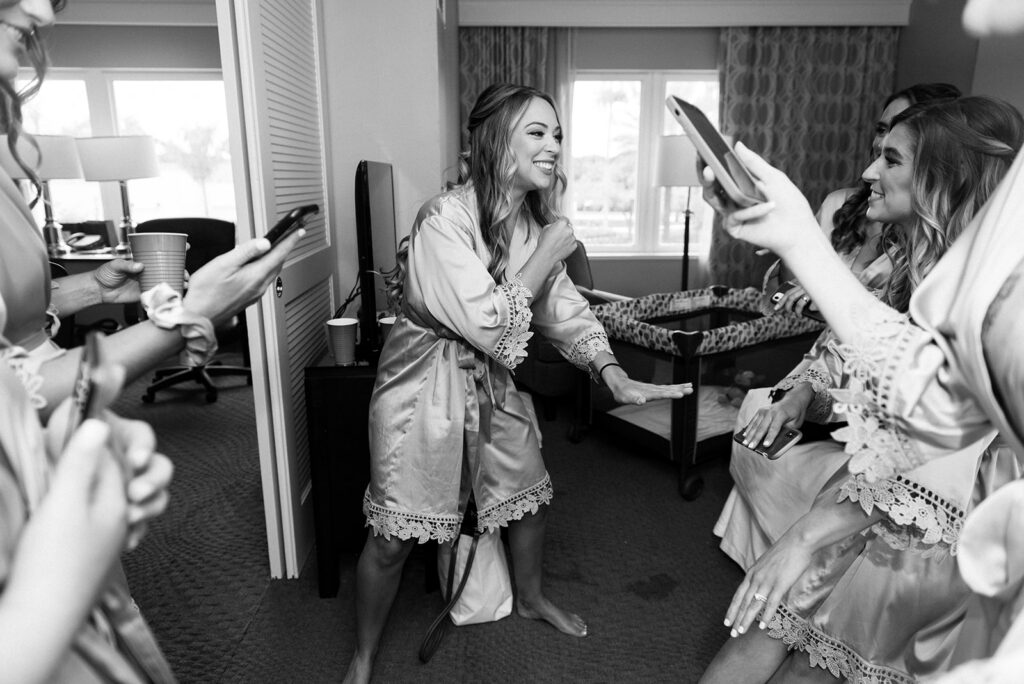 bride and bridesmaids in silk robes dancing