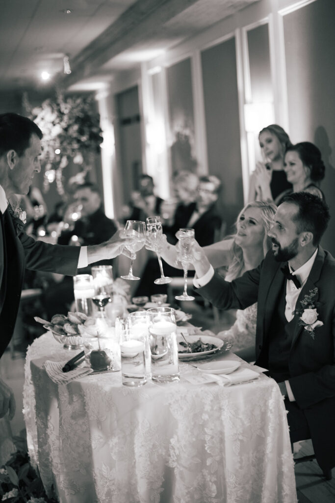 black and white photo fo bride and groom champagne toast