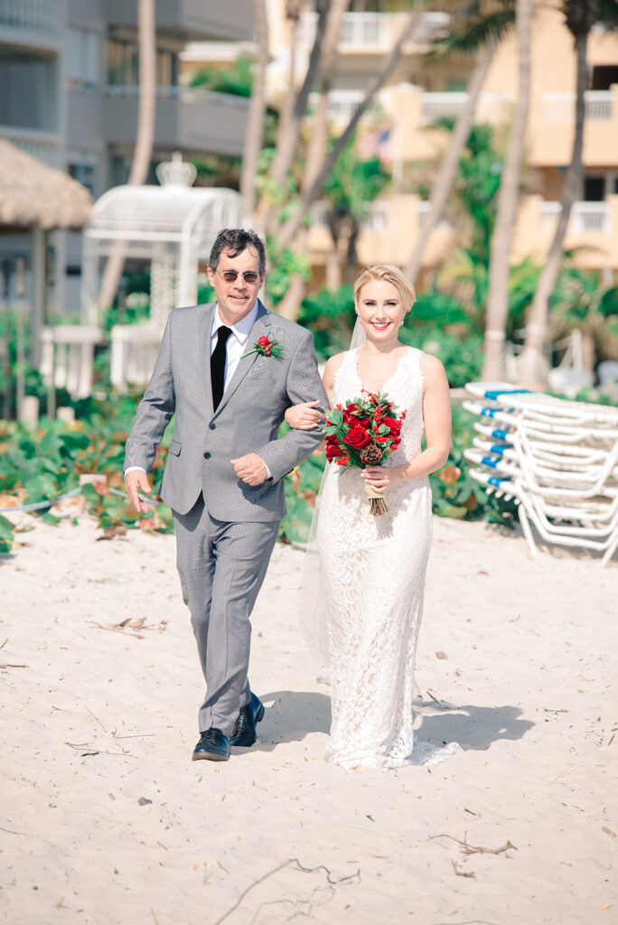 father walks bride down aisle at beach wedding