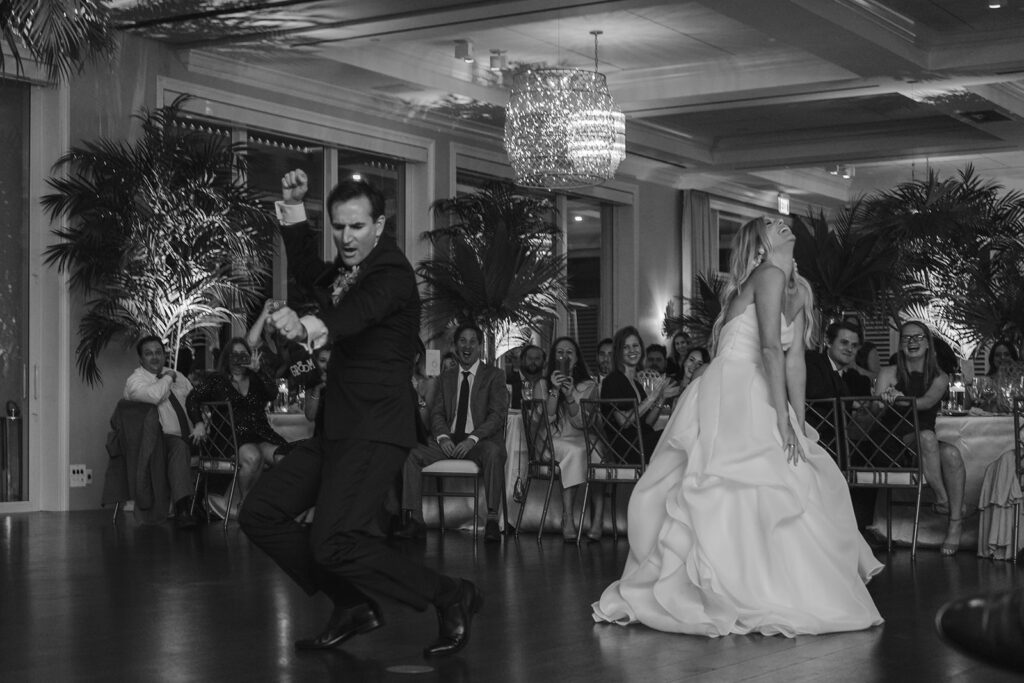 blakc and white photo of bride and groom fun first dance