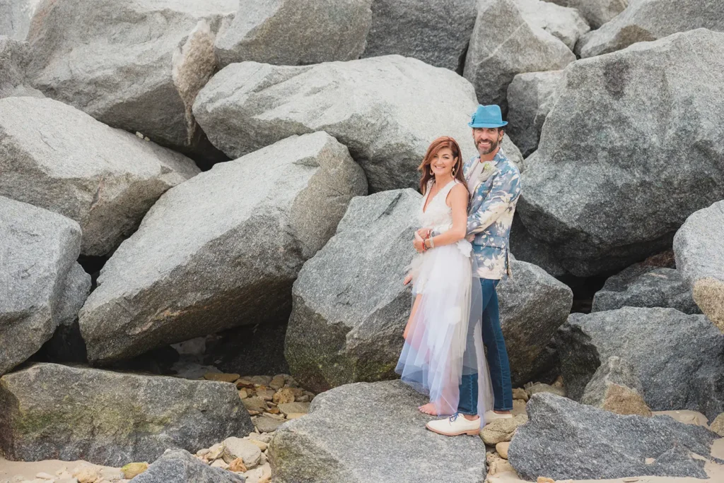 bride and groom standing among large rocks in South Florida