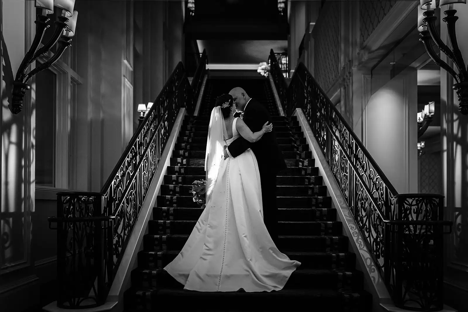 Black and White photo by Cona Studios of bride and groom on stairs at Ritz Carlton Orlando