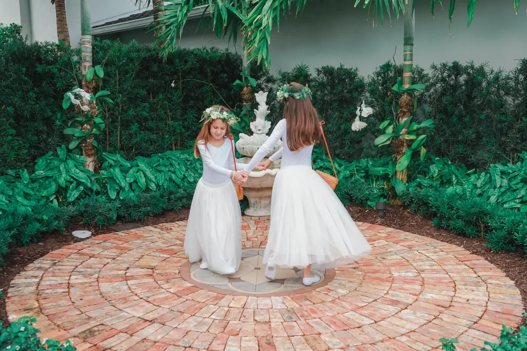 flower girls dancing near a fountain