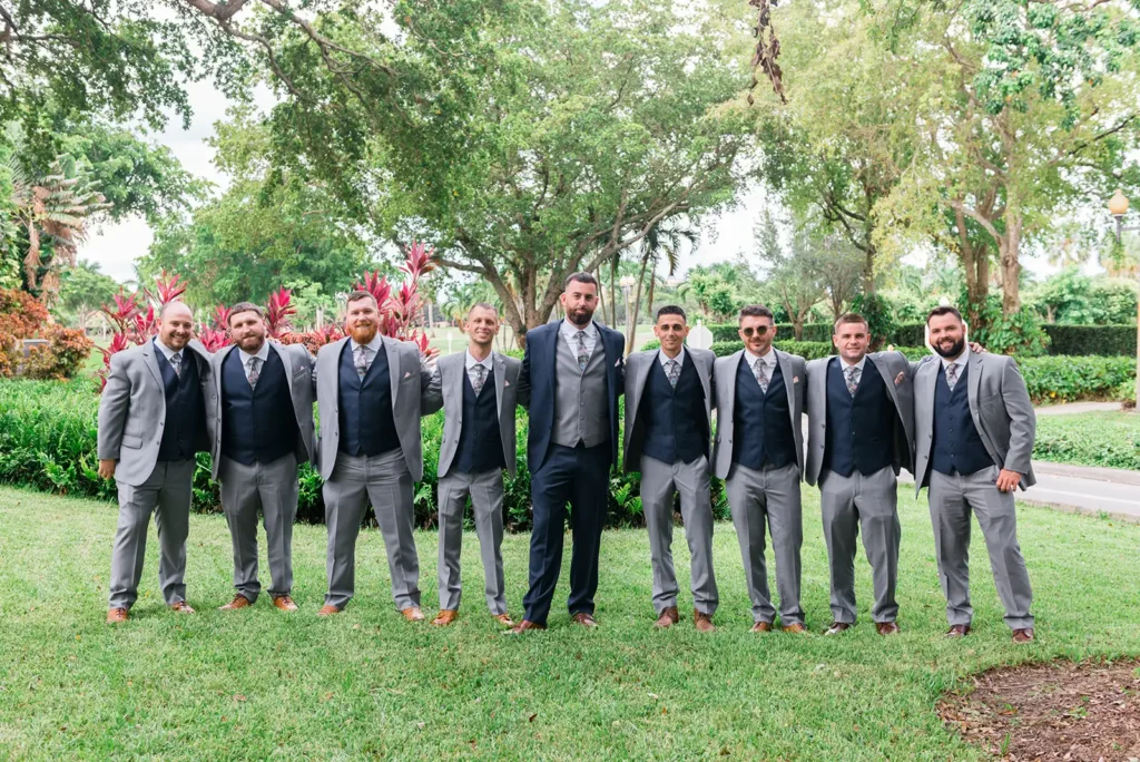 groom and groomsmen wearing suits and vests