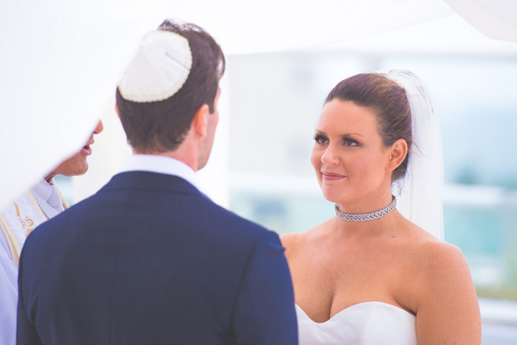 bride smiles into grooms eyes at Jewish wedding