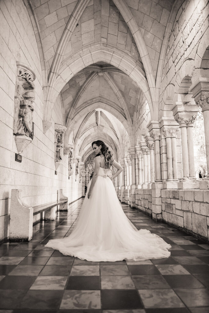 black and white photo of bride in cathedral