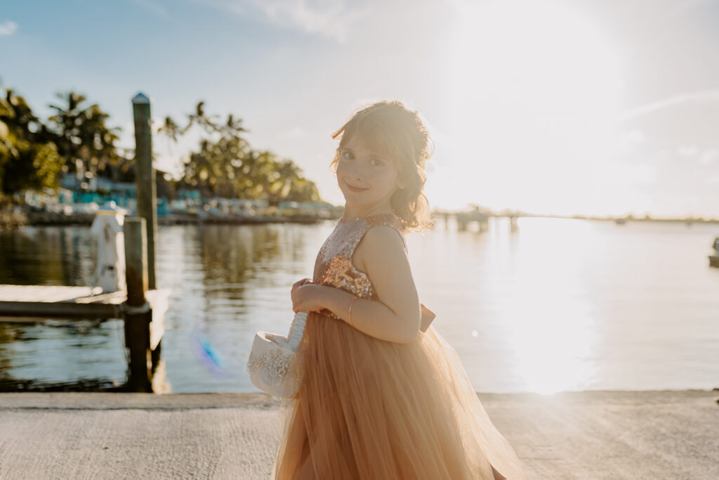flower girl standing in sun rays