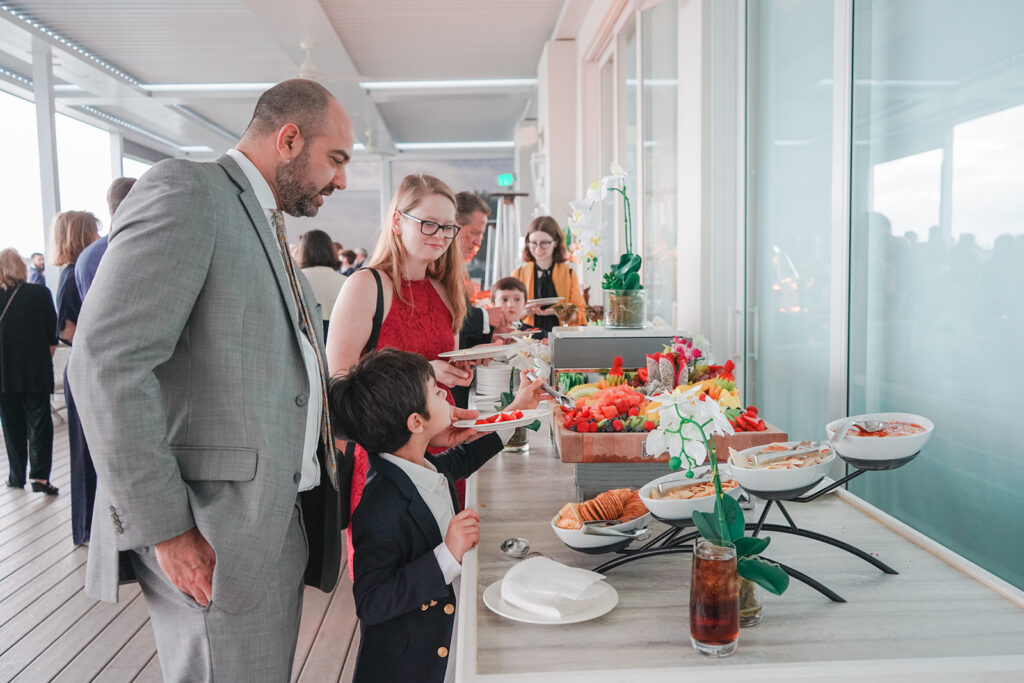 wedding guests enjoy food at cocktail hour