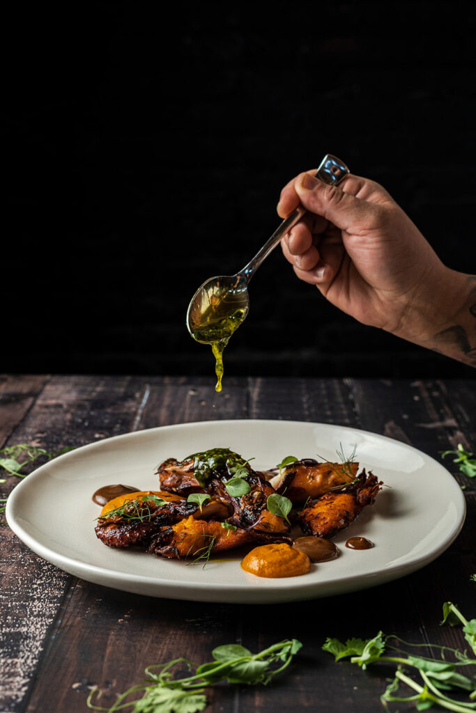Spoon pouring sauce over food Rum Room Miami