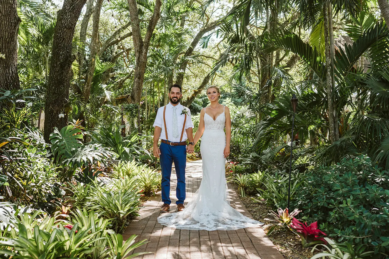 Bride and groom standing amongst a canopy of trees