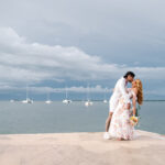 Groom dipping bride on a dock oceanside in South Florida