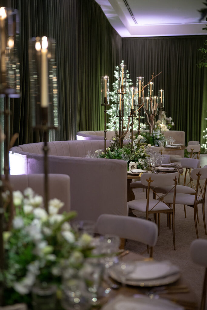 Layered wedding reception table decor with florals, linens, candles