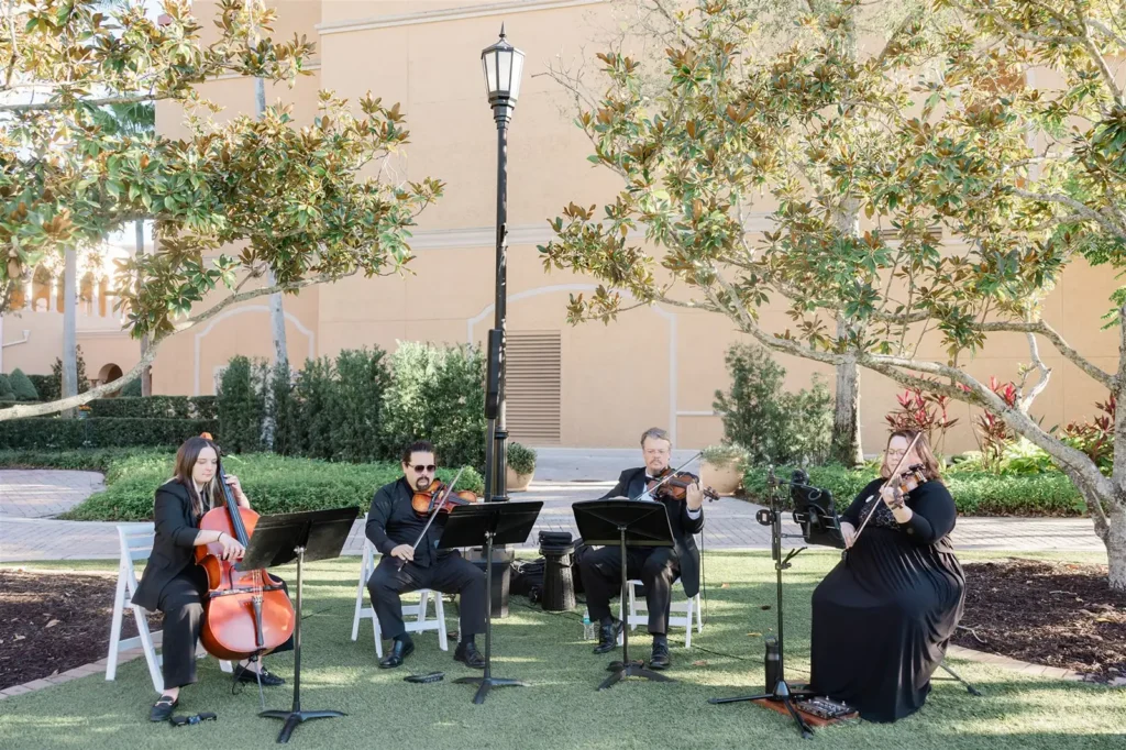Four piece string performance at an outdoor wedding ceremony