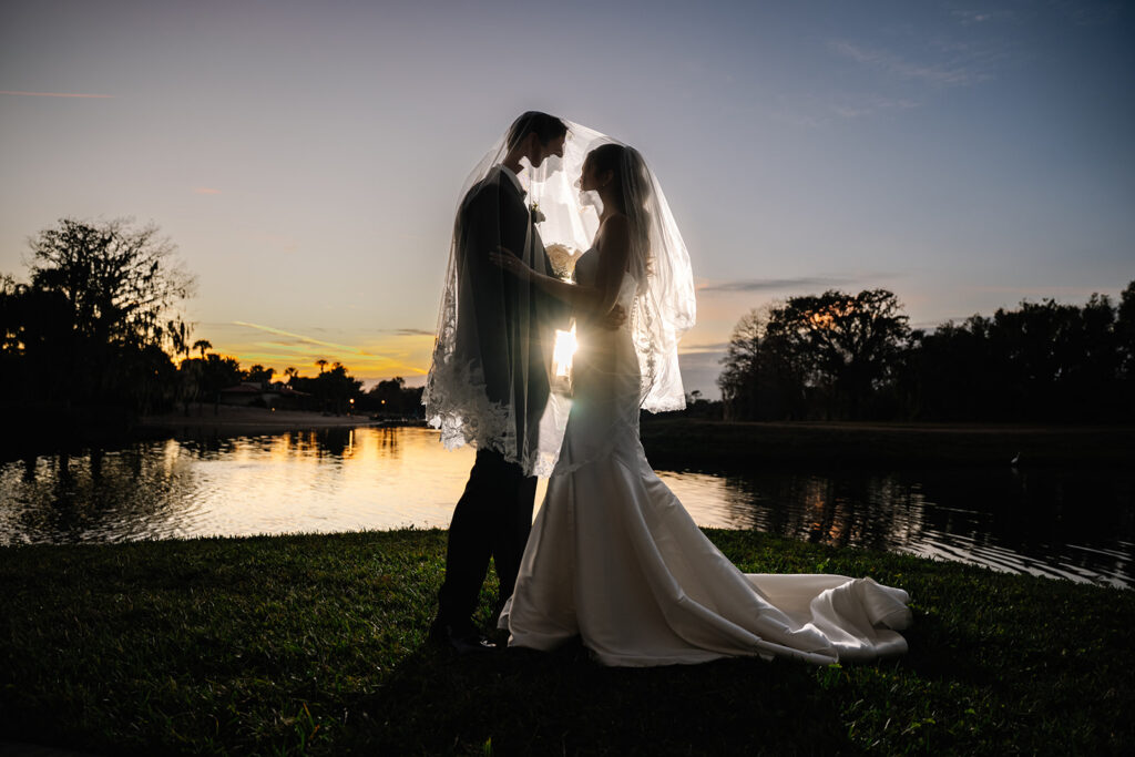 backlit silhouette of bride and groom photographed by Cona Studios
