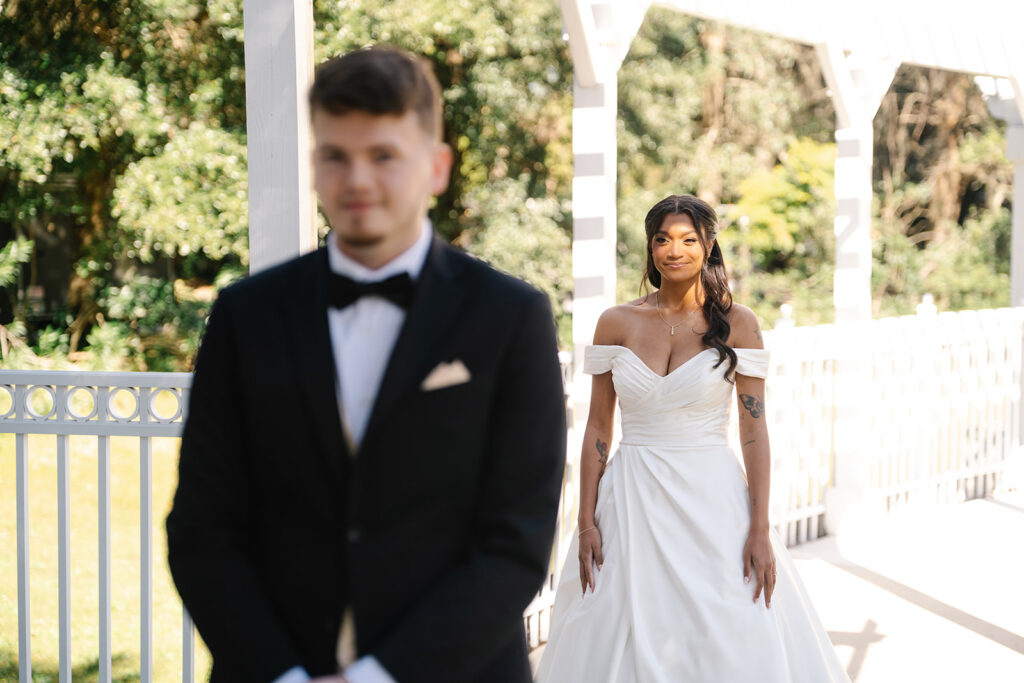 bride and groom first look at an outdoor wedding under a gazebo