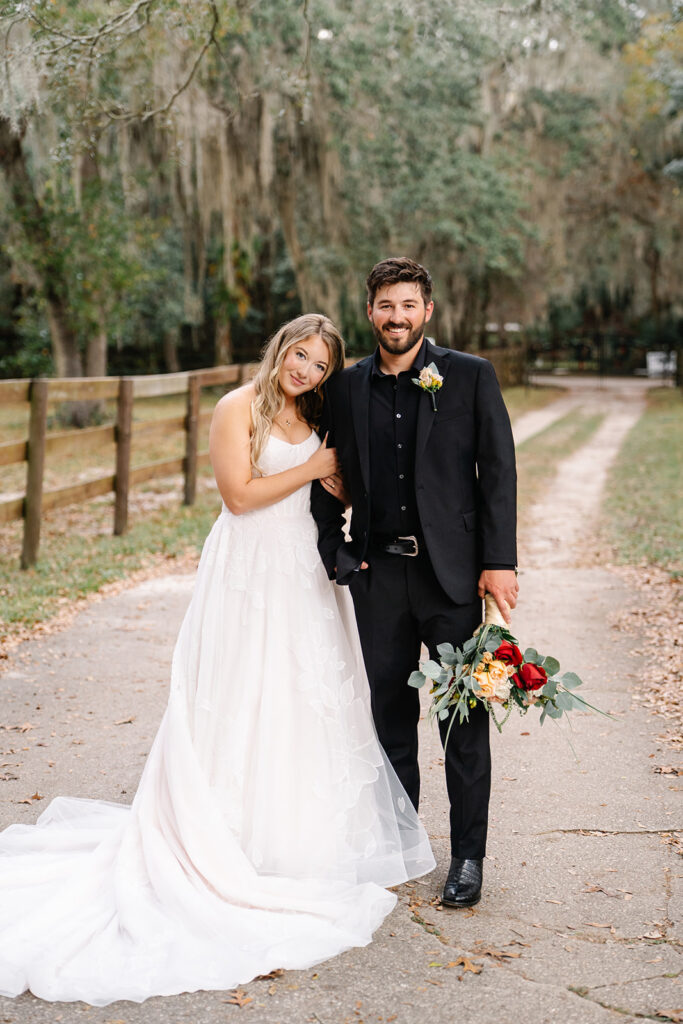 Bride and groom standing on a dirt road at a Central Florida wedding venue