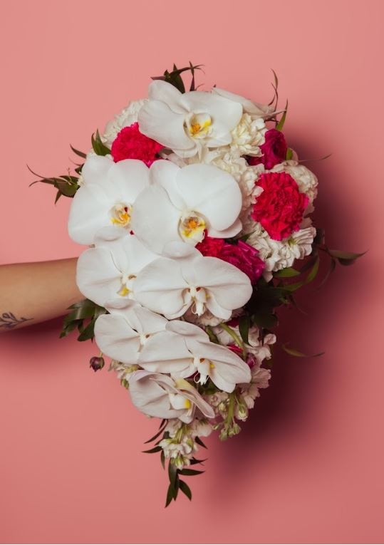 cascading bridal bouquet of white and red flowers