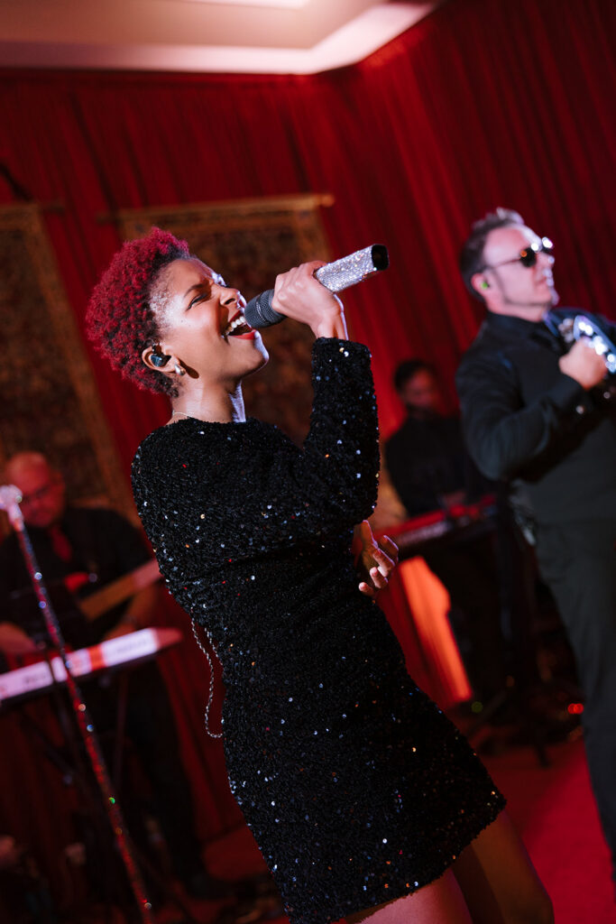 female singer performing on stage at a wedding