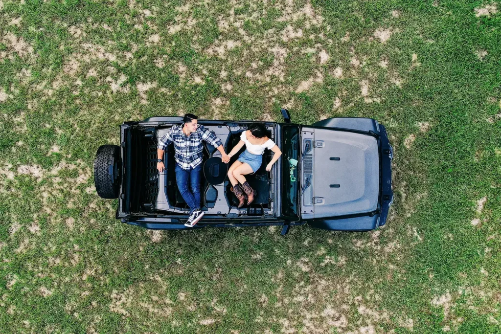 Drone photograph of couple sitting in jeep engagement photo by Cona Studios, FL