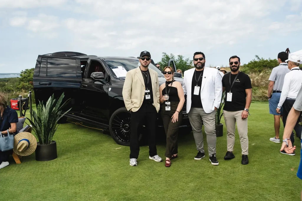 Guests in front of a black truck at The Bridge IX event