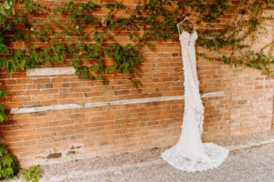 bridal gown hanging on brick wall in UK
