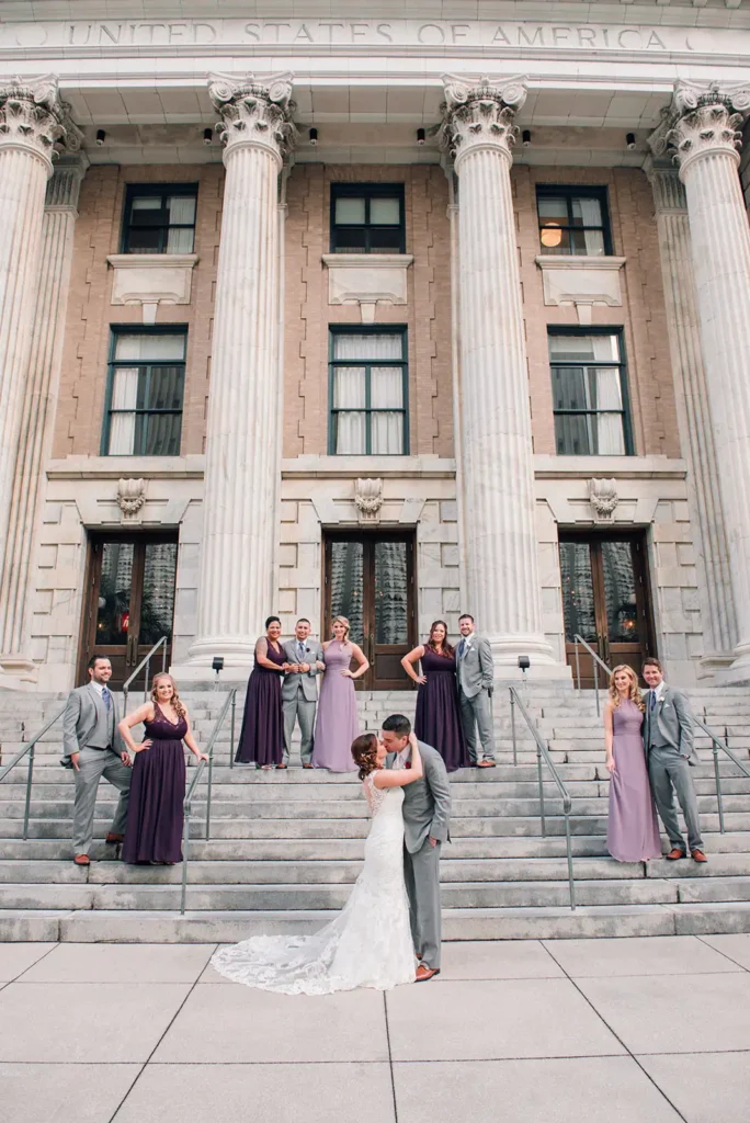 Bridal party standing ou stairs at large US building