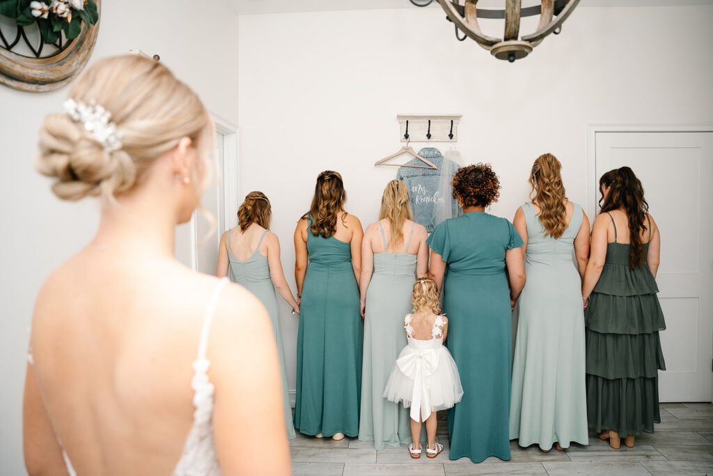 bride first look with bridesmaids and flower girl