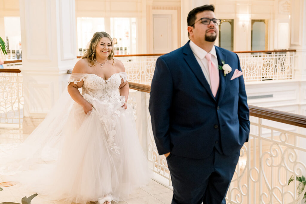 bride approaches groom for first look at Disney