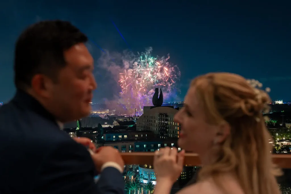 Bride and groom watching Disney fireworks from Swan Reserve