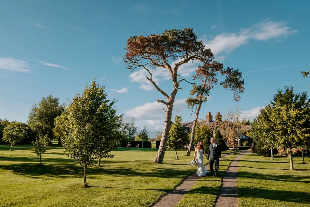 Bride and groom walking down drive at destination wedding venue