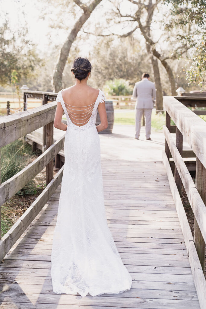 bride approaches groom on walkway first look