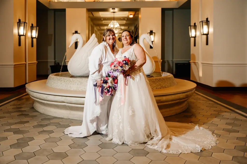 Brides with colorful bouquets by Swan fountain at Walt Disney World Swan and Dolphin Resort