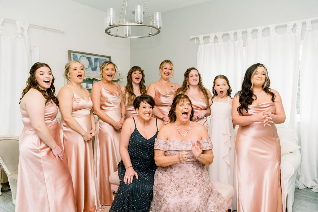bridesmaids and moms excited to see bride