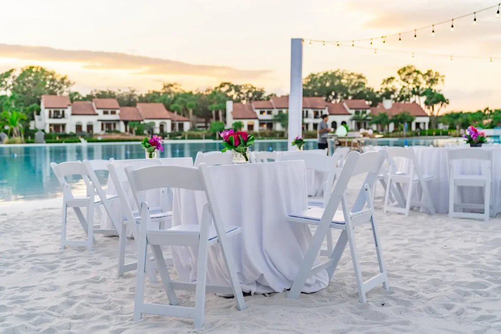 White linens and chairs on beach at event at Conrad Orlando