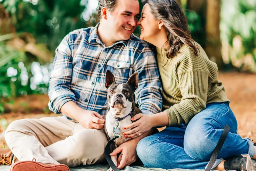 Couple sitting with dog for engagement photo