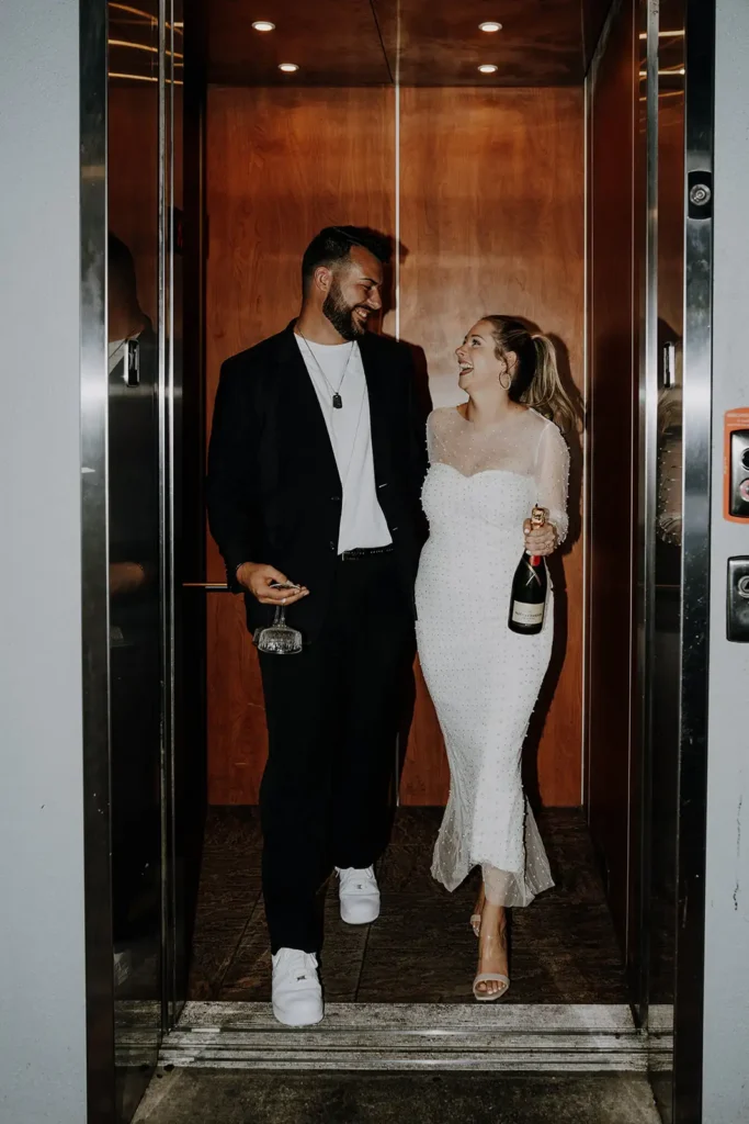 Couple in elevator with champagne