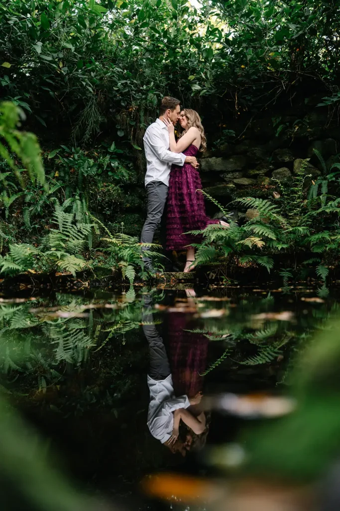 Couple kissing reflected in pond