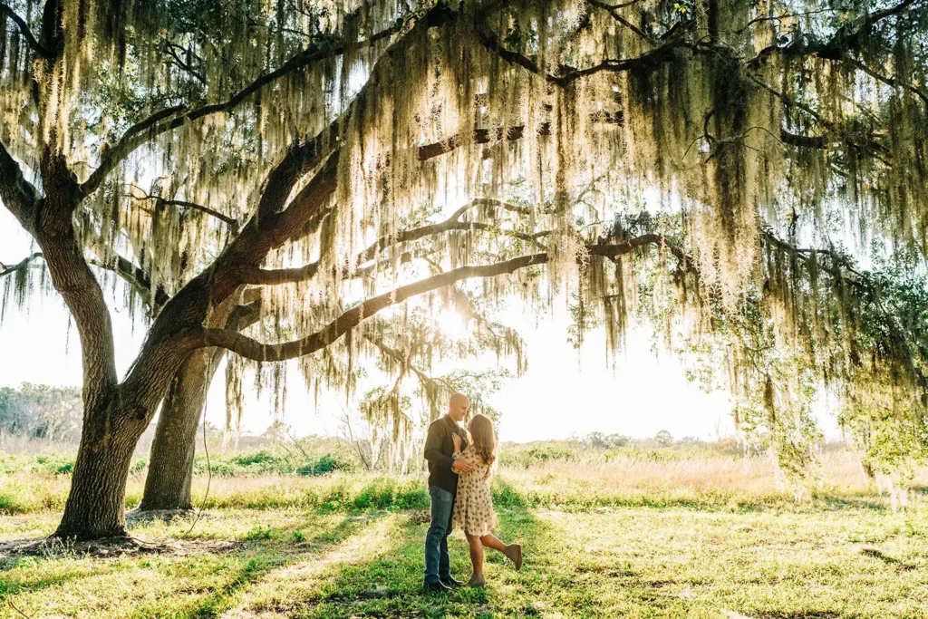 Couple under large tree in park in Florida
