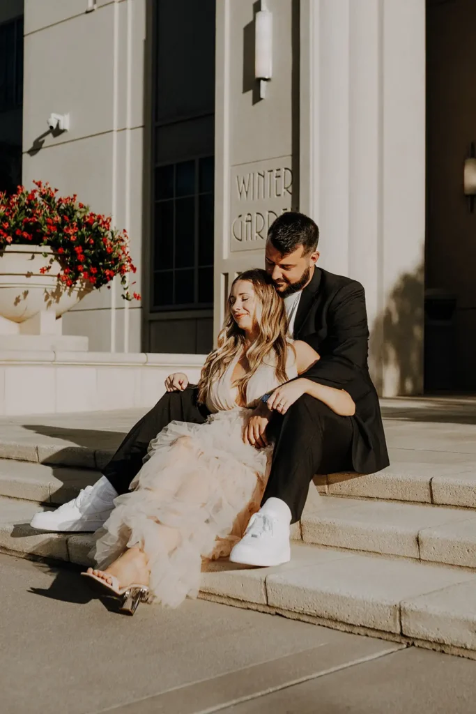 Couple sitting on stairs in Winter Garden