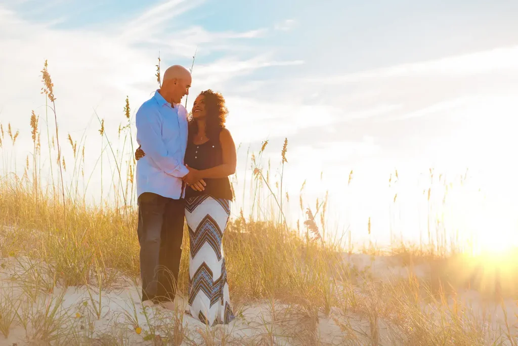 Man and woman standing on sand dune