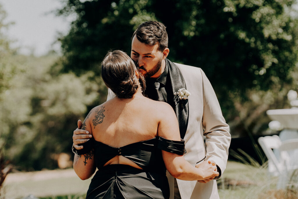 Brother kisses sister at wedding first look