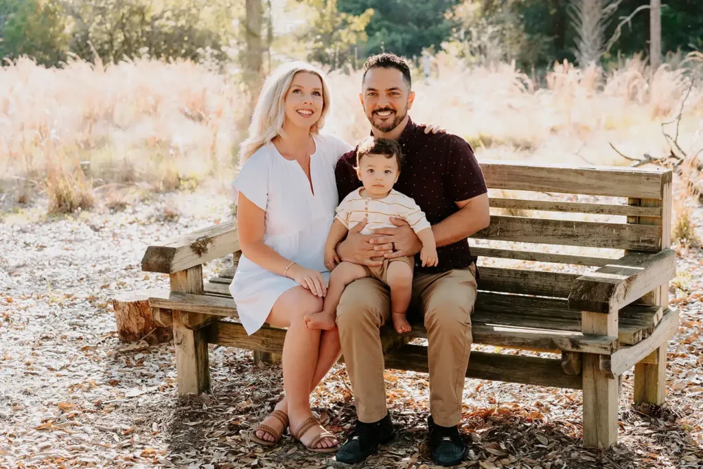 Family photo with mom, dad, son on beanch
