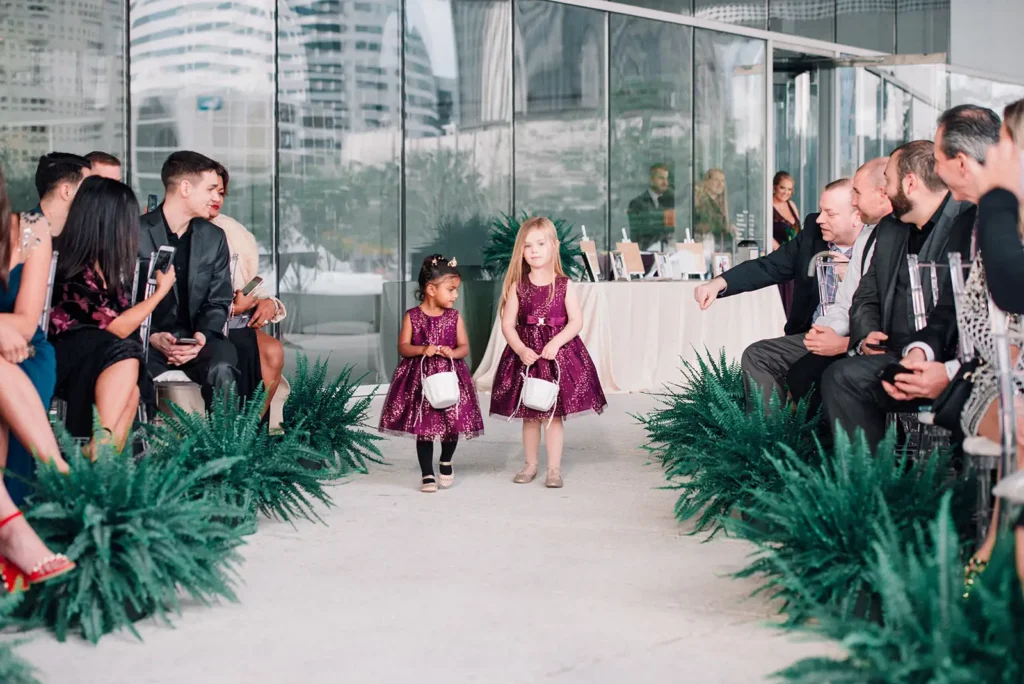 two flower girls walking down the aisle in Tampa, FL
