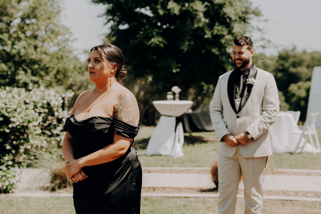 groom approaches sister for first look at wedding