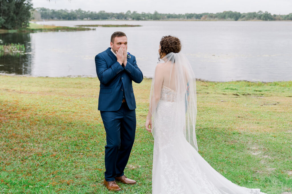 groom covers mouth when he sees bride