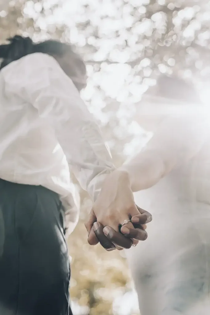 Couple holding hands for engagement shoot