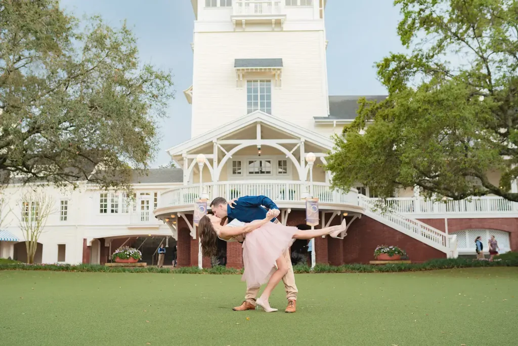 Man dips woman for engagemetn photo at Disney Boardwalk